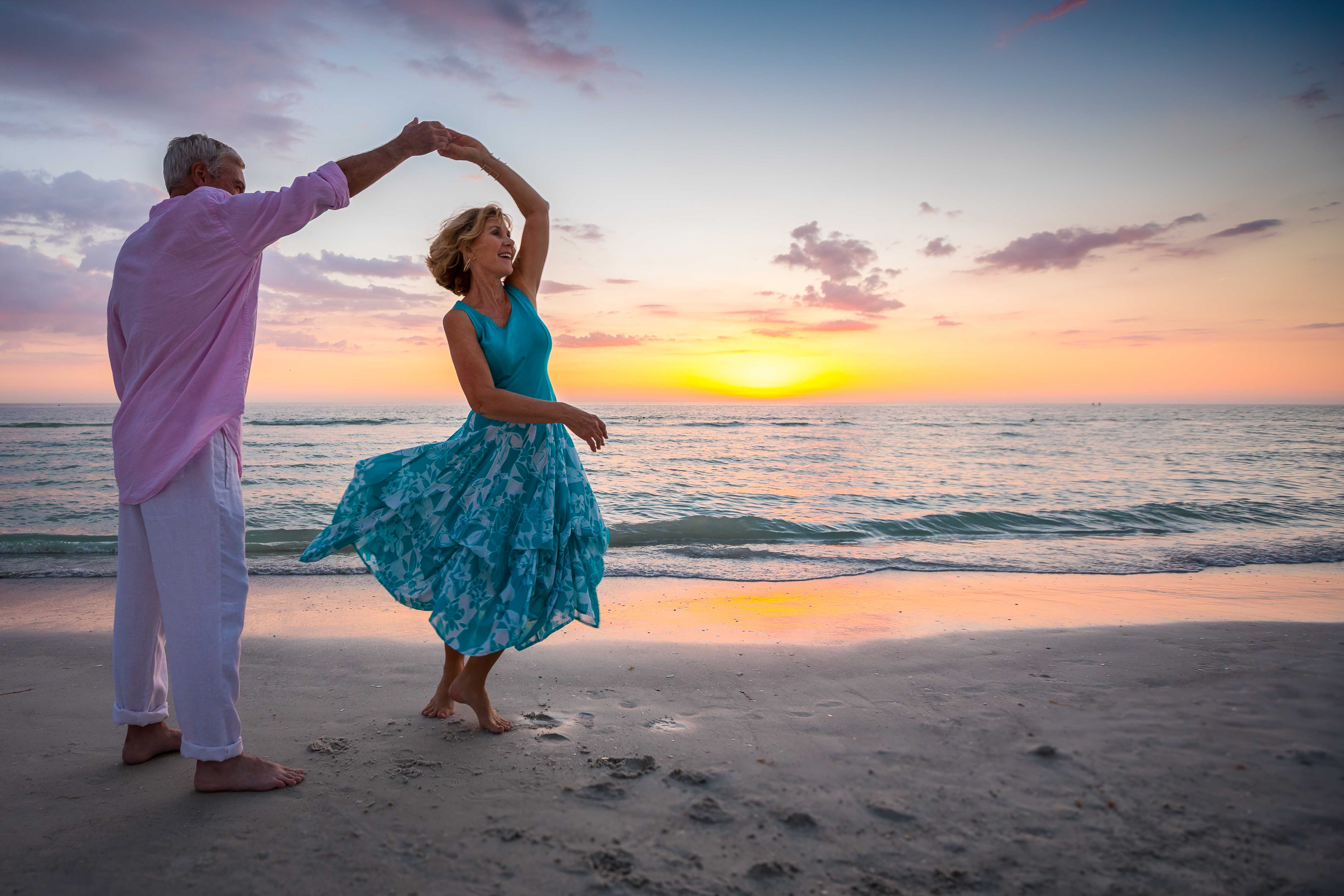 Senior couple dancing at beach