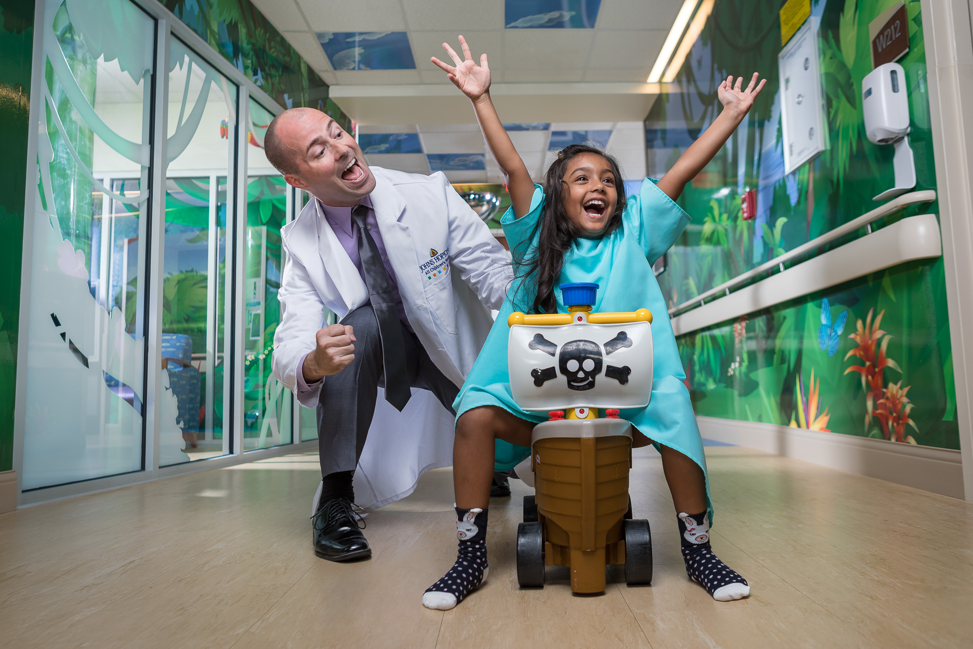 Doctor and patient playing in hospital hallway